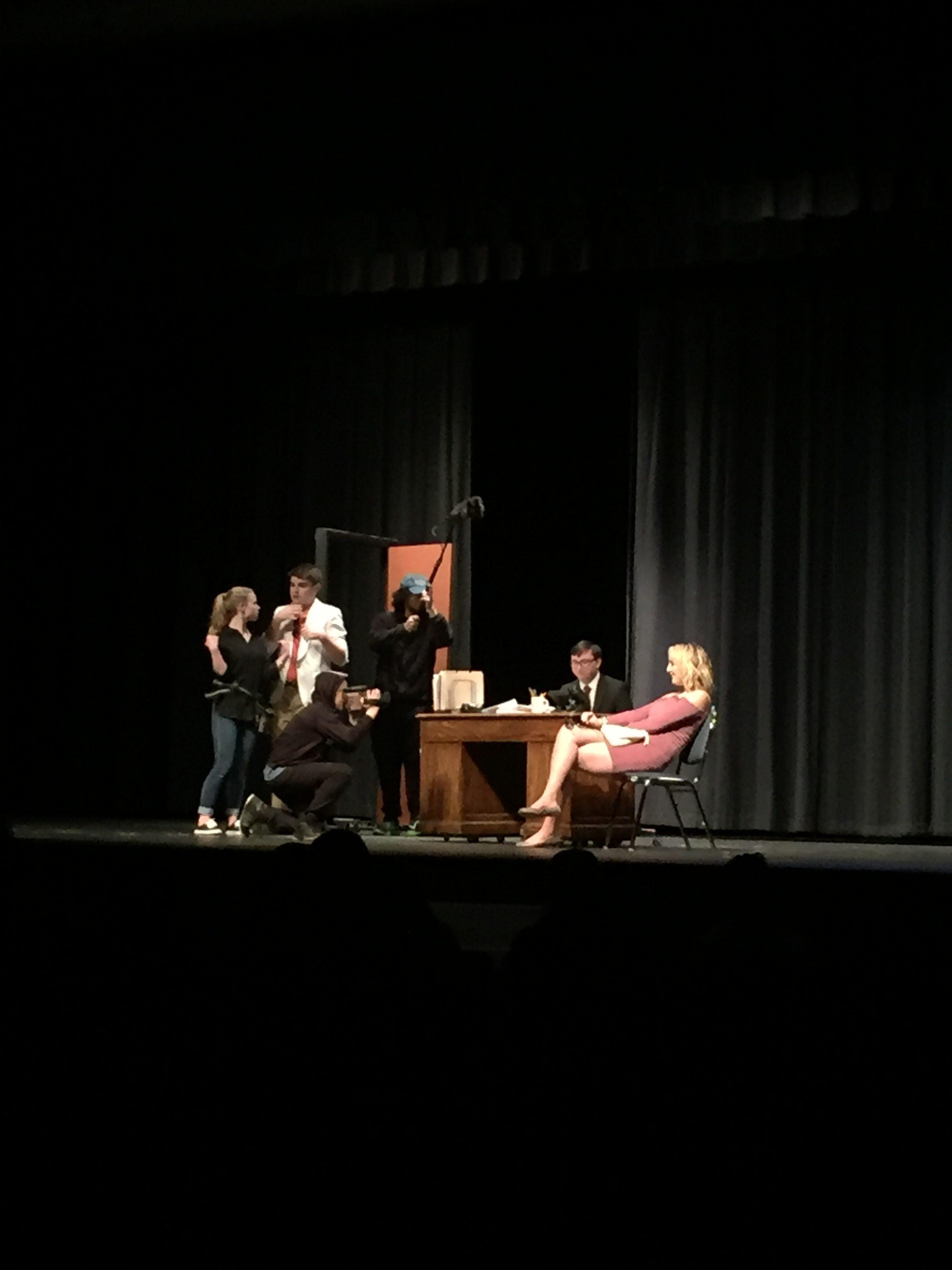 n this scene two investigators are interviewing students that want to attend college. This satirical act was diected by junior Yosef Etana. This was her first directing and not acting.