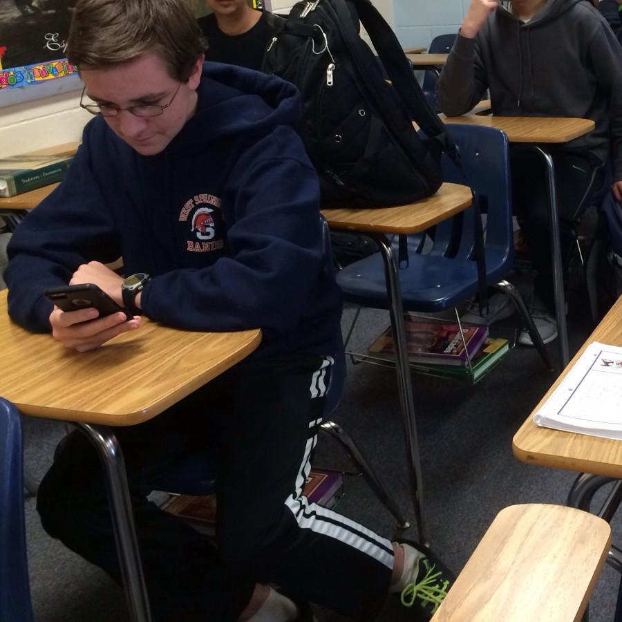 Sophomore+Peter+McAuliffe+uses+his+phone+during+the+day+while+sophomore+Greyson+MacKinnon+uses+the+time+to+read.++Teachers+are+trying+to+reduce+the+usage+of+phones+because+of+its+distraction.