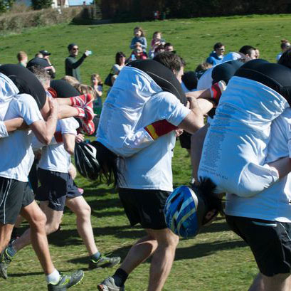 A wife-carrying competition with many participants shown fighting to see who is the best of the best in their unusual and unpopular sport.