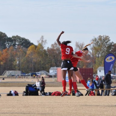 Senior Emily Keast celebrates with a teammate on her travel soccer team, seperate from high school. She is a WS Varsity track runner as well, and balences the two sports, while recieving offers to play both in college.