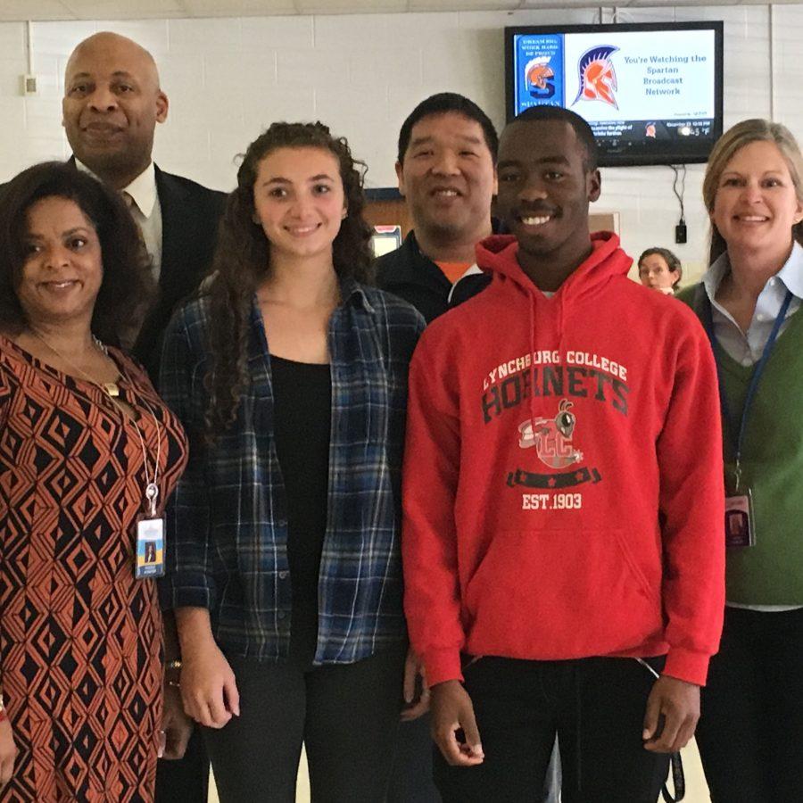 Senior Rodney Wrice and junior Audrey Wever stand with
administrators and a Mars Company representative following
the success of their “Throw Shine” campaign.