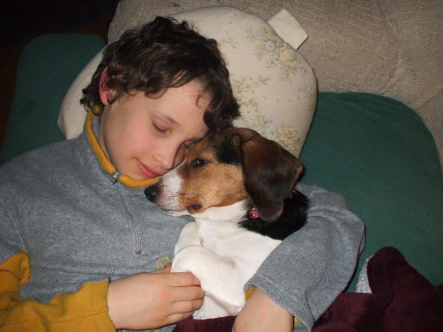 A young Stevens is pictured, peacefully resting with his dog.  The sweet, loving attitude displayed here is similar to his approach toward life: Spread happiness everywhere. This is the spirit in which we remember him. 
