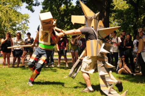 Two people compete in a one-on-one duel in the park. Cardboard tube dueling started back in 2007 with the founding of the CTFL and the sport has grown in popularity since.