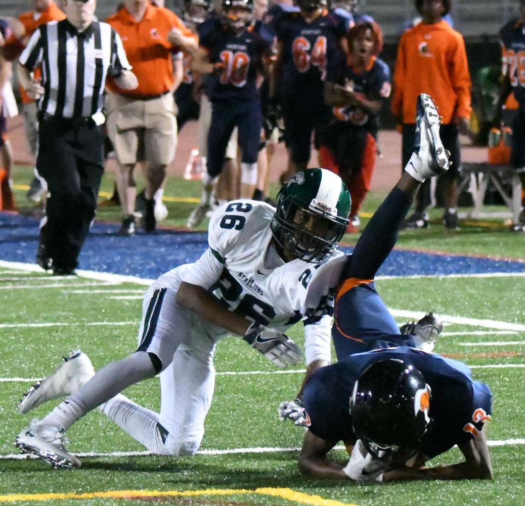 WS Varsity football player goes up against Sputh Country’s defender in a fall game earlier this year. The helmets that both players wear help to protect them from clashes like this one.