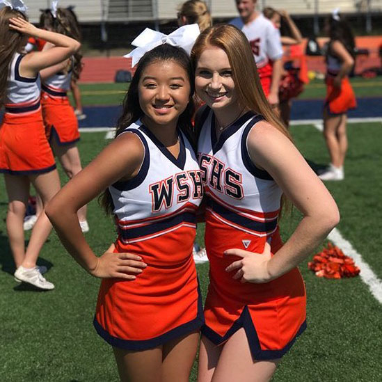 Cheerleaders Rachel Nguyen and Megan Seykowski pose for a photo during a summer practice.