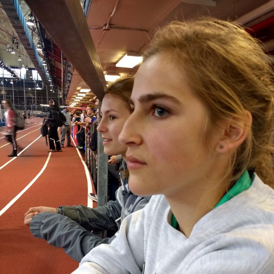 Sophomores Katie Orchard and Amy Herrema watch a track meet while thinking of all the homework they have to do.