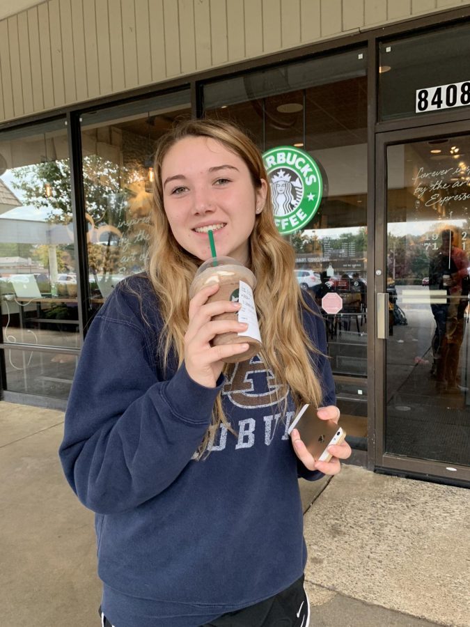 Senior Bailey Eadie sips her pumpkin spice latte outside Starbucks.