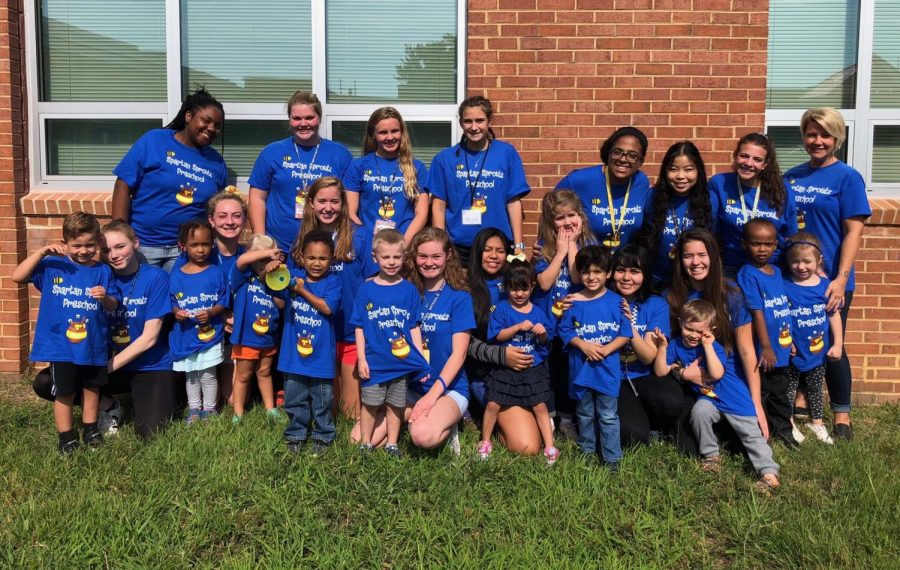 The teachers, students, and children who participate in the Spartan Sprouts program pose for a picture in the school courtyard. Spartan Sprouts pre-school is staffed by students in the Early Childhood Careers class.