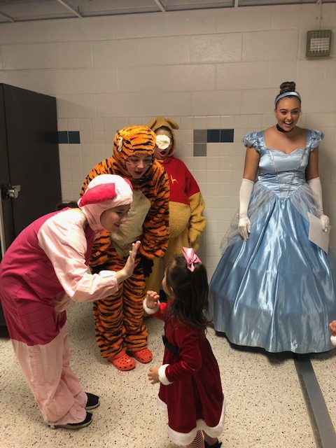 The choir puts on a show for preschoolers from the WS community. Sophomore Alex Park plays the role of Piglet while seniors Bailee Padget, Jenna Mastando, and Emily Norton dress as Tigger, Winnie the Pooh, and Cinderella, respectively.