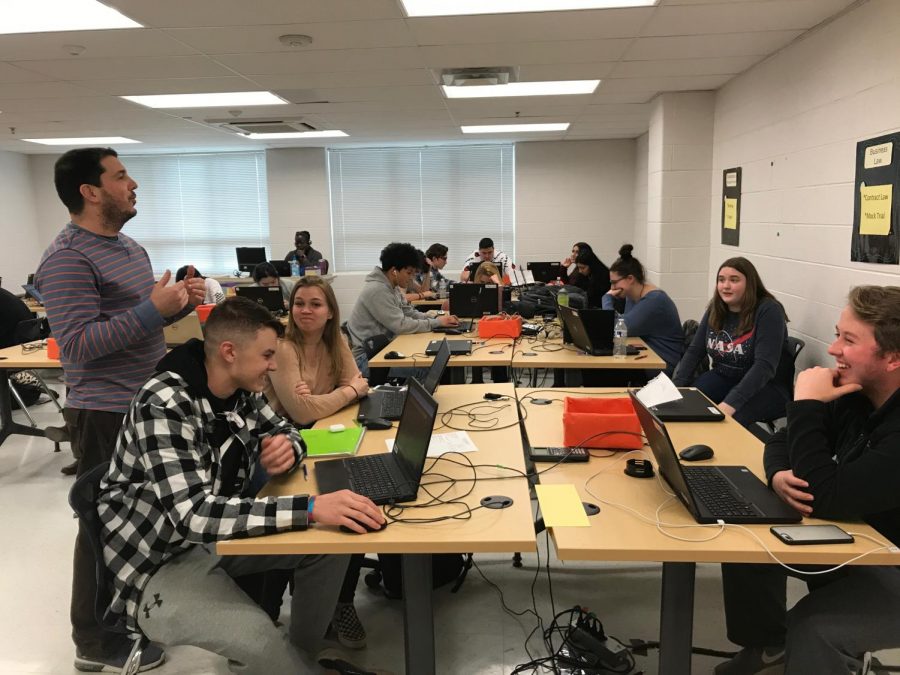 Personal Finance and Spanish teacher Jason Eldridge works with his fifth period students. Next year he will teach WSs new Combating Intolerance course, available to all students. 