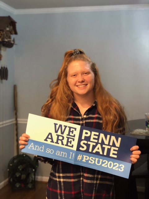 Senior Haleigh Morris holding a banner declaring her acceptance into Penn State, the university she plans to attend in the fall.
