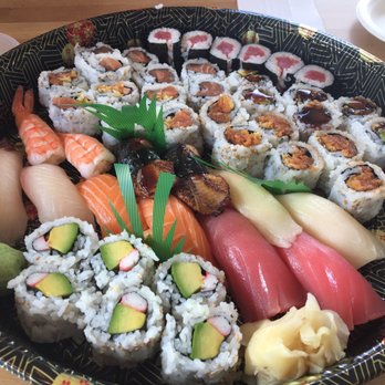 Above is a sushi platter from RAWR Sushi that includes sashimi sushi and rolls such as California Rolls and Spicy Crunchy Salmon Rolls.