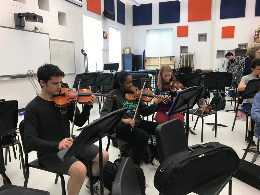 Members of the pit orchestra attend a practice after school in the band room. It takes weeks of hard work for the student musicians to master the difficult music.