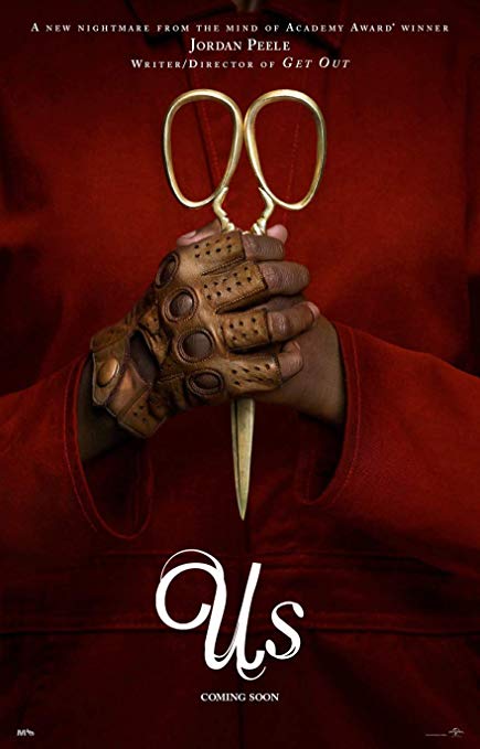 The movie poster for Us shows a mysterious pair of hands clutching sinister scissors.