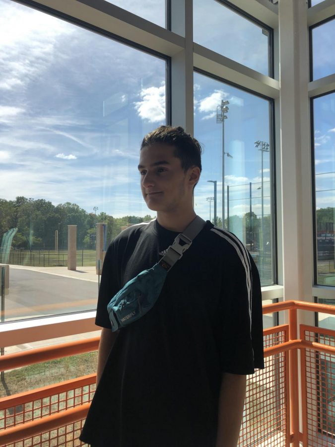Freshman Gabriel Es-Haq poses with a new fashion trend in the south stairwell. This fanny pack is from Waterfly. It is the sports model, and it is available for $14.99 on Amazon in a wide variety of color choices.