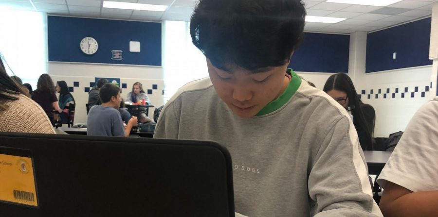Senior Eric Jung working on AP Government homework on his FCPSOn laptop. Due to the new one-on-one laptop decision, classwork and homework have become more technology and laptop-based.