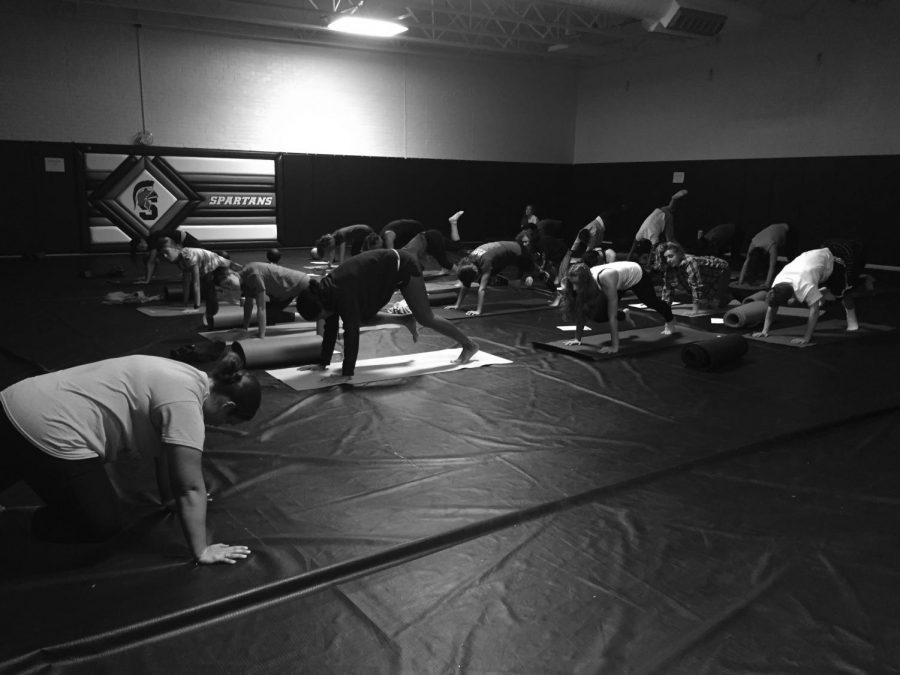 Rosie Donaldson teaches her sixth period yoga class in the wrestling room. Yoga consists of many stretches and poses and is beneficial to both ones overall physical and mental health.