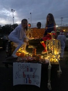 Senior Julia Ricci (left) and Dana Brown (right) show off their festively decorated trunk for the Military Ambassadors Club.