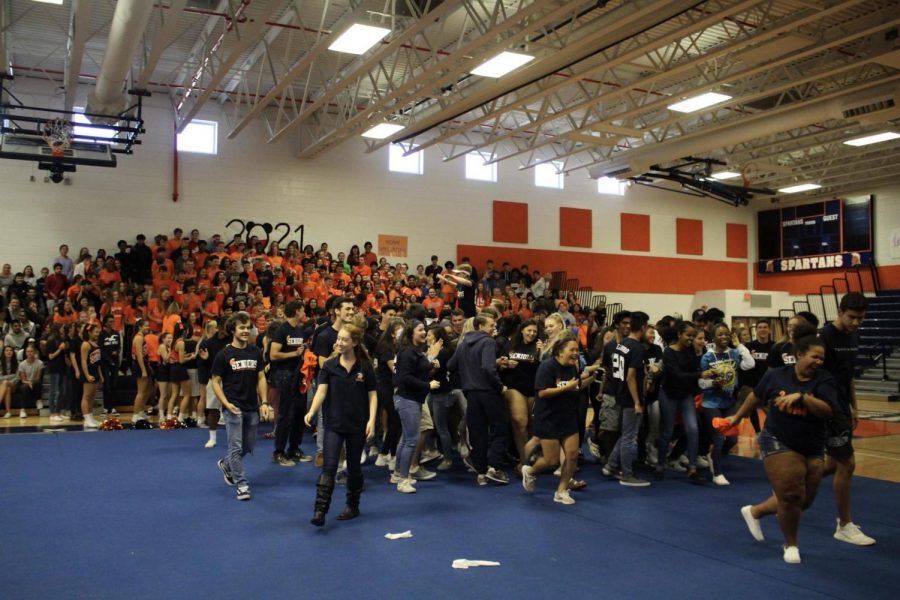 Seniors and Juniors wearing navy and orange on the class colors spirit day as they attend the Homecoming Pep Rally on Thursday.