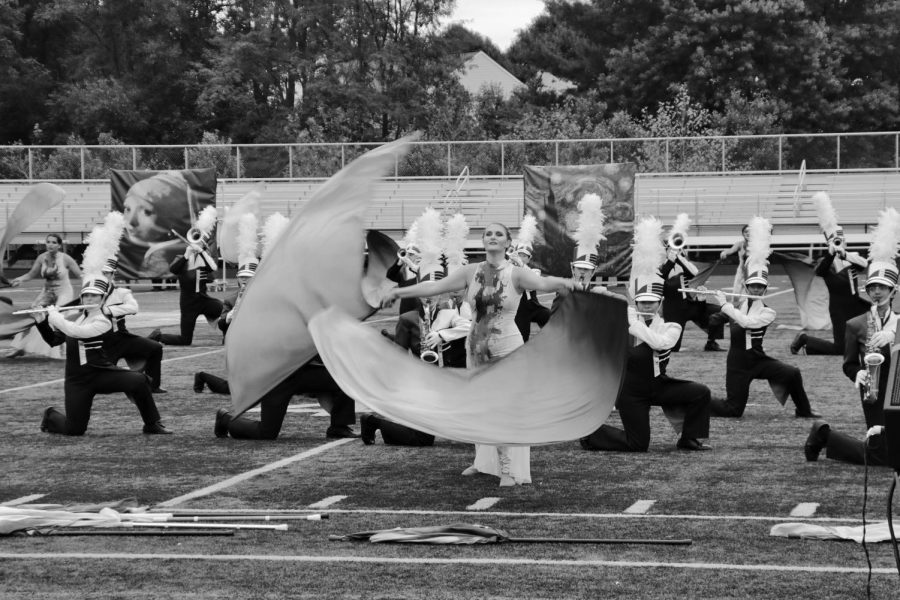 Sophomore Jaqueline Welsh waves her flags to the choreography during the performance at the Loudoun Valley competition. The color of the flags represents the emotions of an artist.