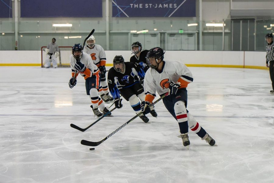 Three Spartans battle for the puck during a November 1 win against Centreville/Fairfax. WS won in commanding fashion 11-3, earning them their first win of the season at The St. James.