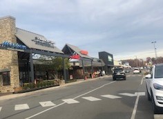 The Old Keene Mill Shopping Center with a crosswalk and multiple stores. This afterschool hangout spot had been undergoing construction and being renovated. The construction is finally coming to an end and the new plaza holds potential to become an even more popular spot than it was before.