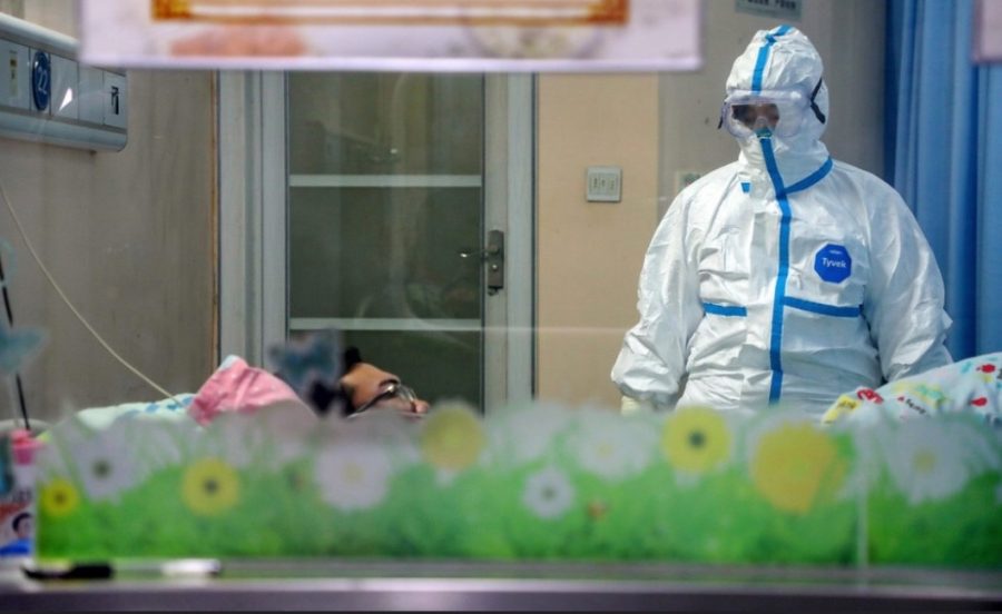 A doctor treating a coronavirus patient in the new Thunder God Mountain Hospital that was constructed in late January for the treatment of the coronavirus. Doctors have to fully cover all skin, as the virus is highly contagious.