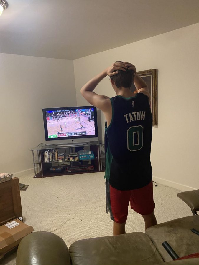 Senior Peter Montavon watches in distress as his beloved Boston Celtics struggle in overtime versus the Miami Heat. Fans of NBA teams making deep playoff runs felt every bit of the tension despite the abnormal circumstances due to the COVID-19 pandemic.