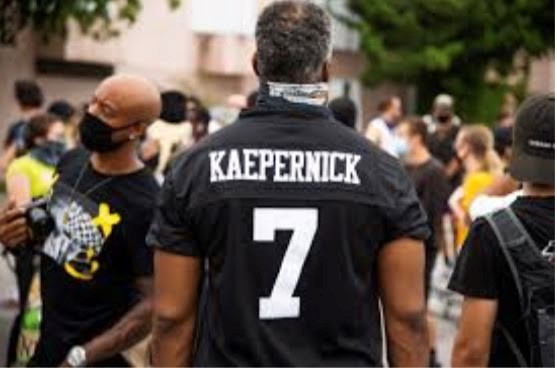 A man wears the jersey of former NFL player Colin Kaepernick to a BLM protest. Kapernick kneeled during the national anthem to protest police brutality in 2016. He has been a free agent since his release from the San Francisco 49ers in 2016.