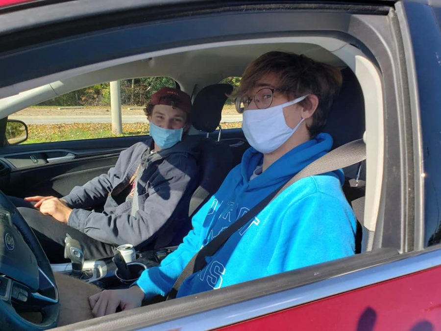 Seniors Matt Zimmerman and John Neumeyer wait in line at South Run for their grab-and go-lunch organized by a group of senior parents.