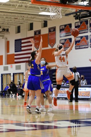 Lexi White shooting during a fast break at the District Championship. She went on to score 14 more points throughout the rest of the game.