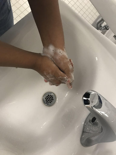 Jessica Faruque following the 3rd step of the procedure, by scrubbing through all parts of her hand. This aspect is shockingly easy yet often missed by many who encounter the bathroom sinks.