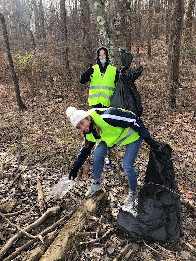 Junior Lexi Stein and sophomore Aidan MacGrath spent a chunk of their time digging out trash from the frozen lake. They smashed through the ice with sticks so they could pull out beer bottles and containers.