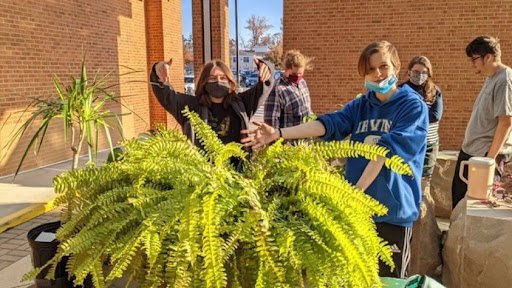 Members of the Gardening Club prepare to plant outside of the school. The club is currently meeting every Wednesday outside Door 2.