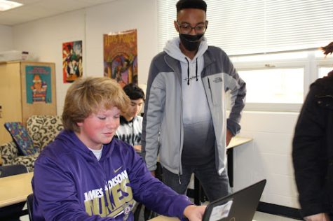 Senior Henry Davis-Jones looks over freshman Stetson Martin’s character designs at the first meeting where they focused on character design and introduction.