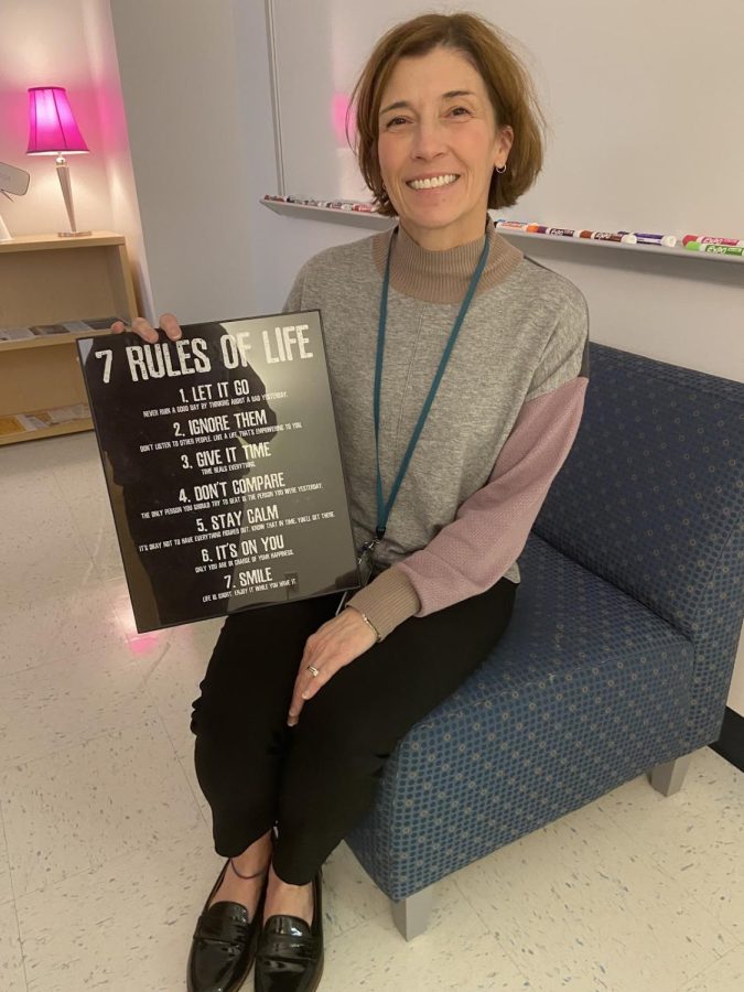 Counselor Arenholz in her office with her “7 Rules of Life” poster, which represents her core beliefs. The rules are: 1. Let It Go, 2. Ignore Them, 3. Give It Time, 4. Don’t Compare, 5. Stay Calm, 6. It’s On You, and 7. Smile.