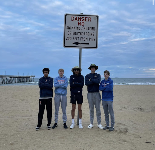 Seniors Vishal Green, Henry Anderson, Ino Puente, Gavin Reichard, and junior Cael Alonzo pose at Virginia Beach during the 2023 indoor track and field state championship. Green, Reichard and Anderson are all current track and field captains, and Alonzo is on track to be one next year. 