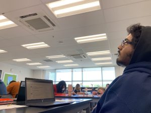 Raghib, frustrated with the cold temperature coming from the school’s air conditioning, tries to stay warm by layering his clothes to stay warm in order to feel comfortable enough to complete his work in class. 