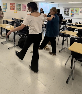 Senior Katie Tragakis is doing the Hasapiko, a traditional Greek Dance. Greek club members are learning the Hasapiko, which they will perform at International Night. 