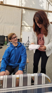 Freshman Max Gerstenberg receives advice from the director of Little Heros, Brittany Goodwin, who is explaining the blocking—in other words, the movements of the characters in the scene—and other aspects of what Gerstenberg will end up acting.