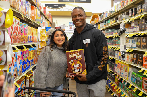 McLaurin offers to sign Crunch Time cereal boxes for Safeway customers and workers. Although the line was long, he was more than happy to reciprocate the love to his supporters.