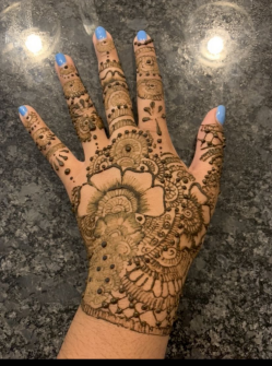 Henna comes in various styles and often consists of repeating patterns. This is an example of an intricate henna design, featuring a variety of floral patterns.