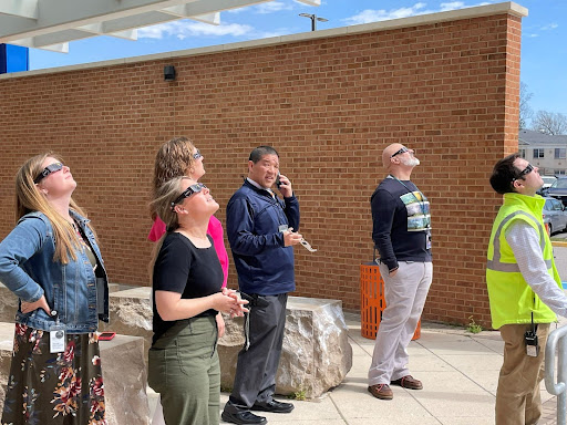 (Left to right) English teacher Brianna Salvato, counselor Taylor Wagonseller, Associate Principal Amy Brown, Principal Michael Mukai, Director of Student Services John Basta and Safety & Security Specialist Brad Adams view the solar eclipse on Monday afternoon.