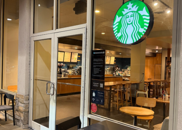 Empty seating inside a Starbucks cafe at night.