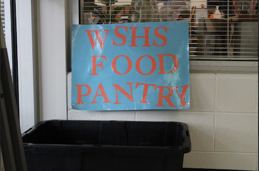 A bin from the pantry is placed in front of the main office, ready to collect donations from students.